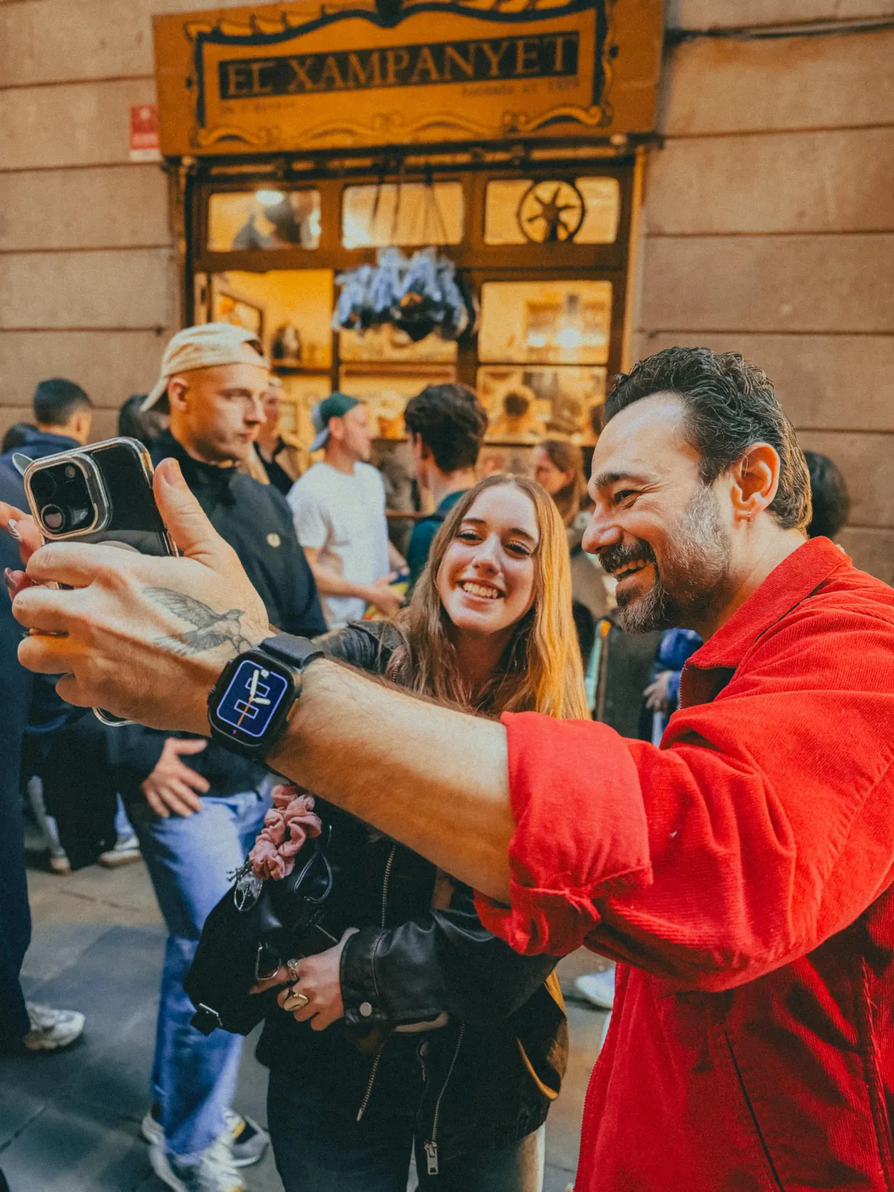 Couple taking a selfie outside El Xampanyet tavern in Barcelona